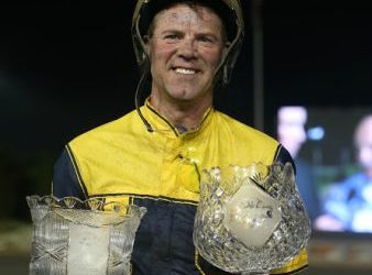 Randy Waples poses with the Metro Pace and Canadian Pacing Derby trophies.